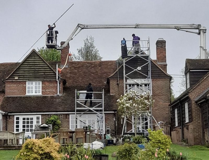 The Roof Moss Cleaners using cherry picker and scaffolding to clean roof safely and professionally in High Wycombe, Buckinghamshire
